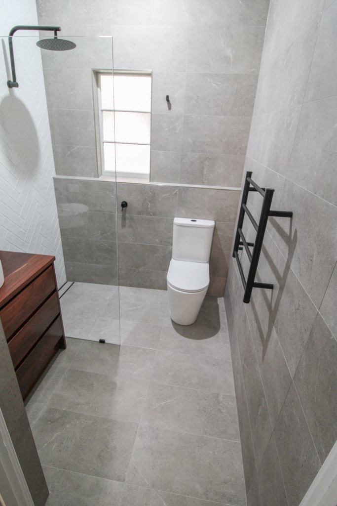 Toilet inside shower area in small Australian wet room bathroom