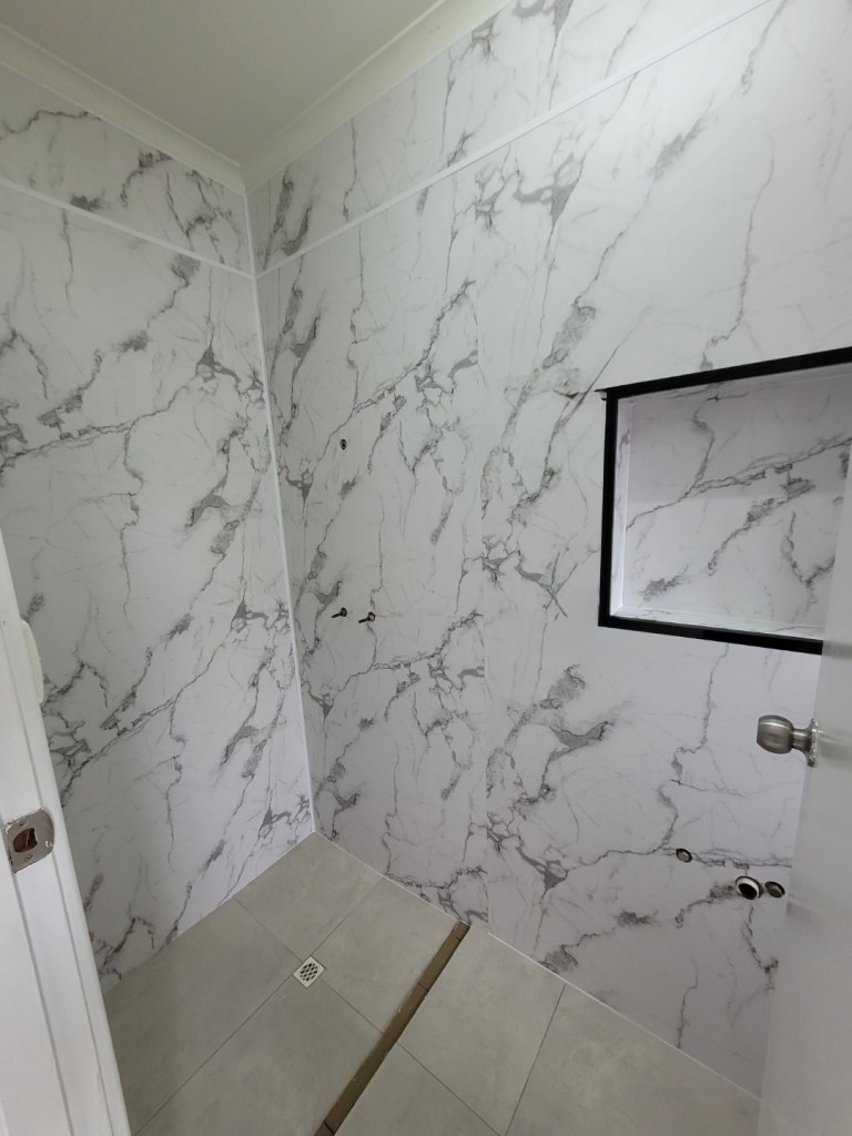 PVC bathroom wall panels installed in shower area