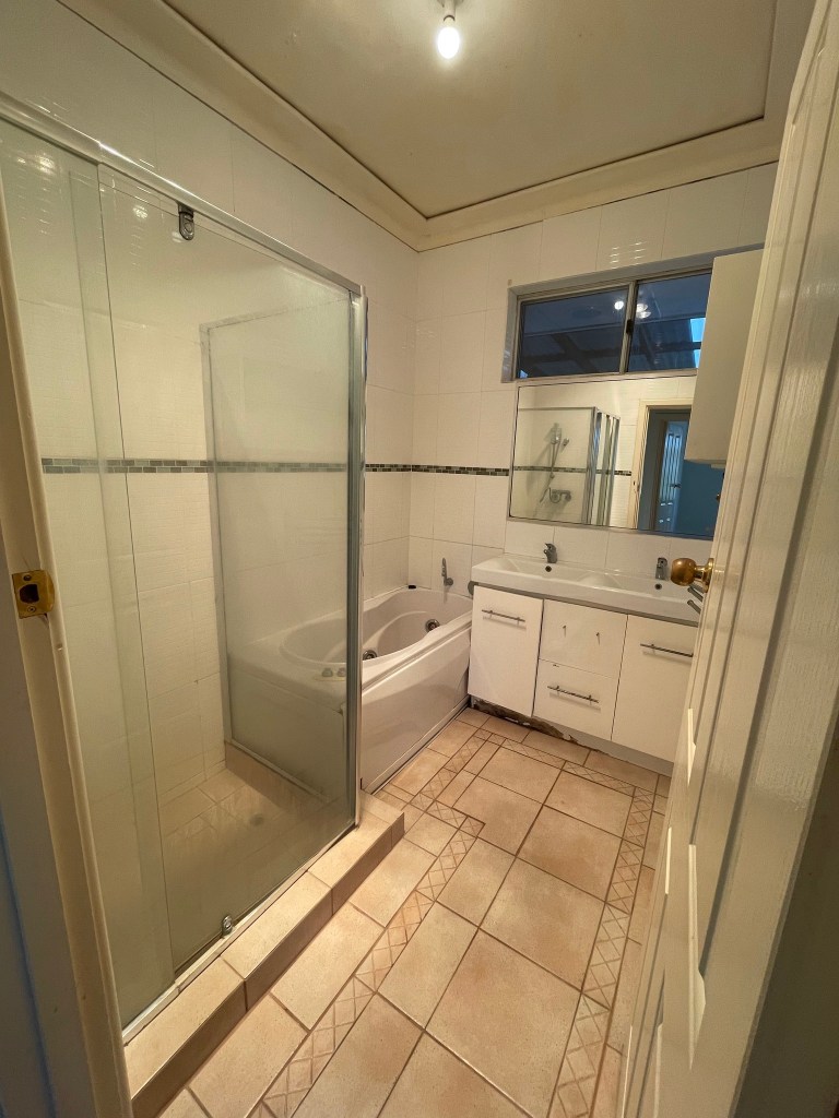 space saving bathroom with mirrored cabinet and recessed shelving