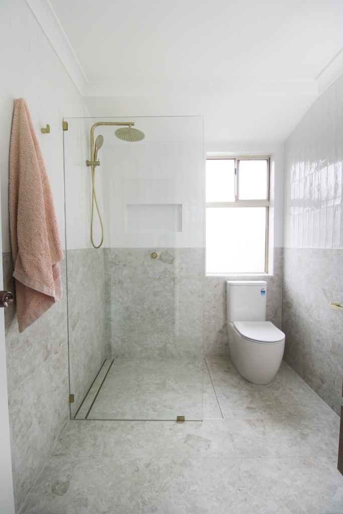 toilet in shower area for small bathroom