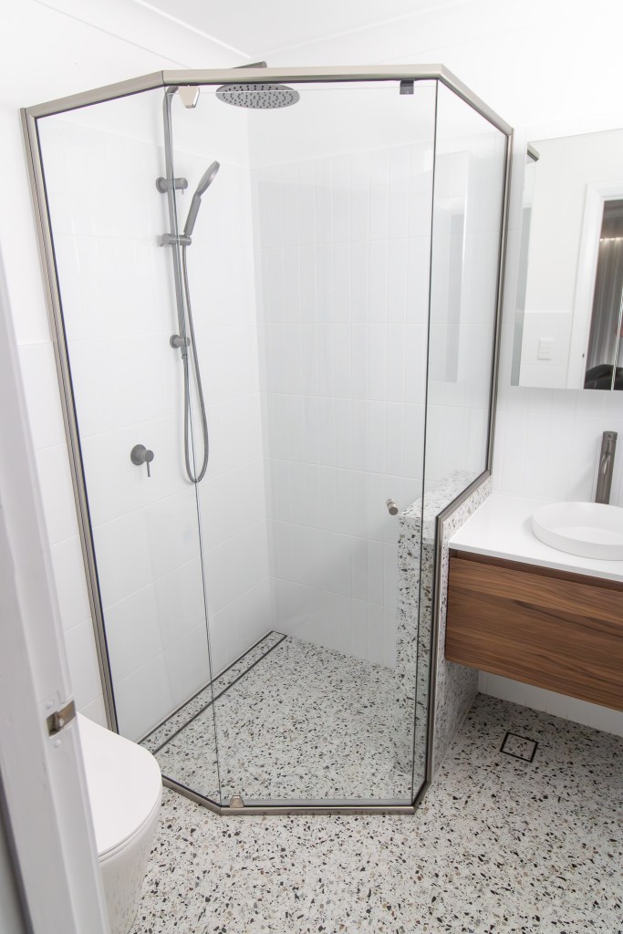 narrow bathroom design with toilet at end and wall hung basin